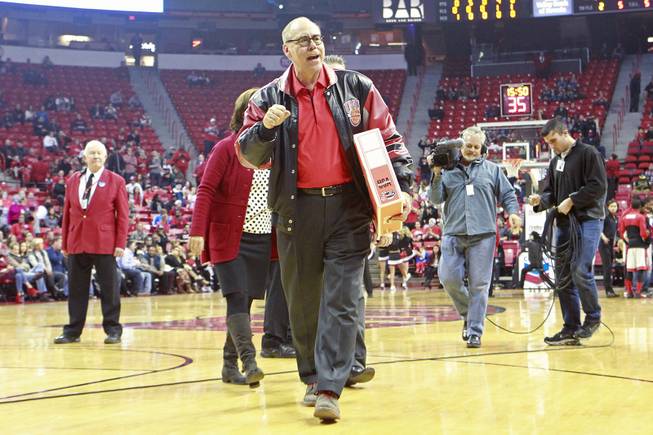 Outgoing UNLV President Neal Smatresk walks off the court after being honored during a timeout in their game against Sacred Heart Friday, Dec. 20, 2013 at the Thomas & Mack Center. UNLV won the game 82-50.
